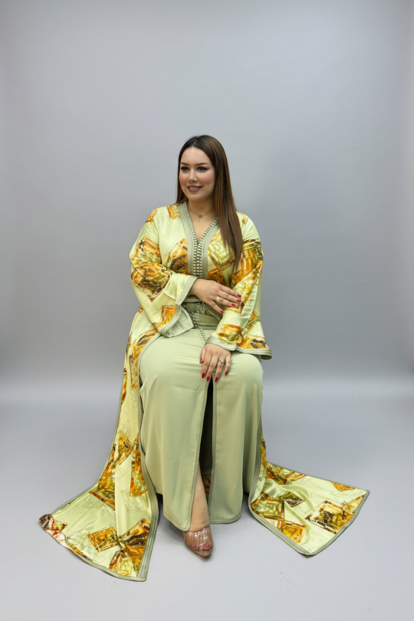 A woman wearing a sage green and gold printed traditional kaftan.