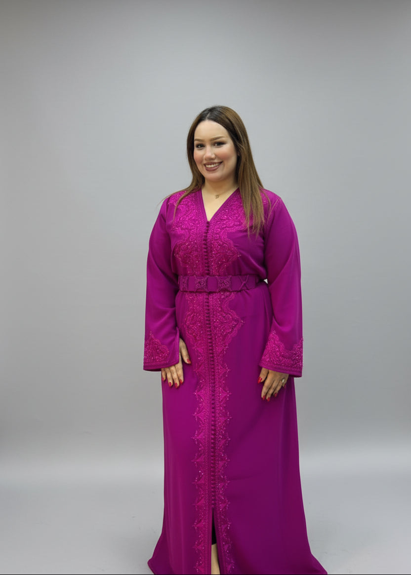 A woman modeling a bright magenta-purple embroidered long kaftan .