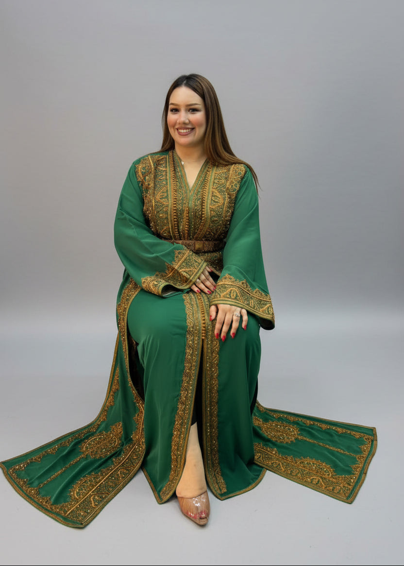 A woman wearing a green traditional kaftan with gold embroidery.