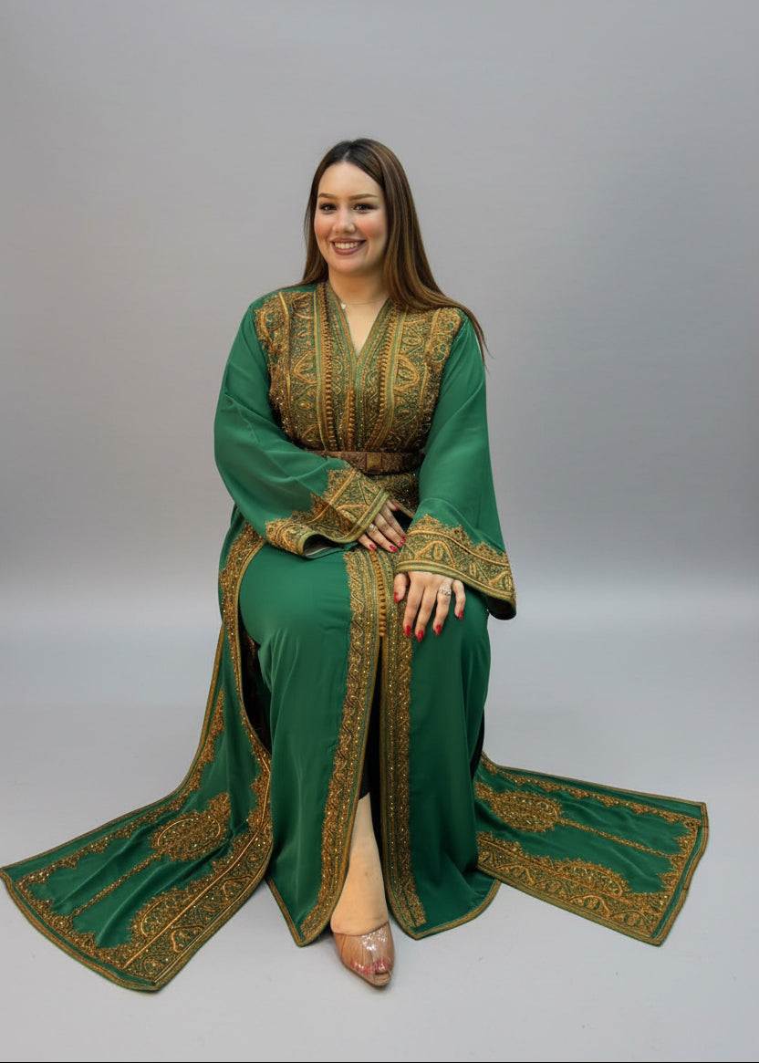 A woman wearing a green traditional kaftan with gold embroidery.