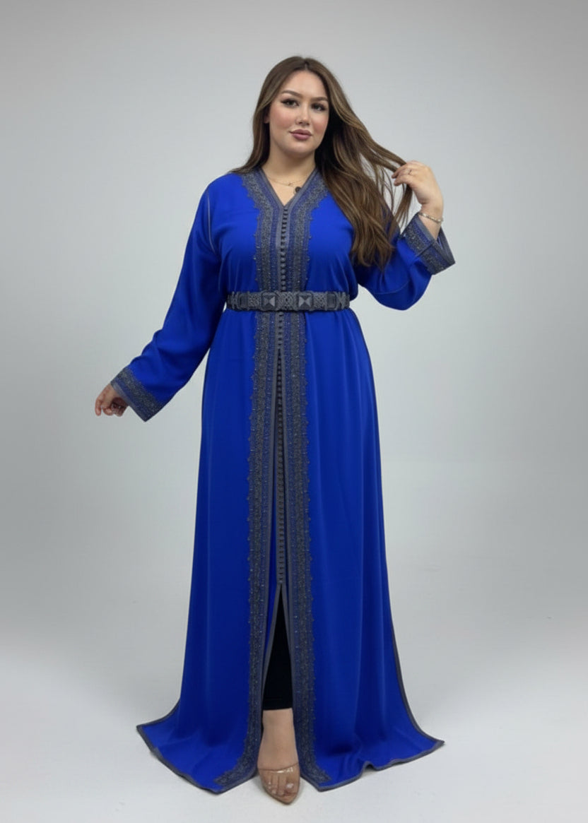Model wearing a vibrant blue caftan with intricate detail and belt, showcasing a modern and elegant style.