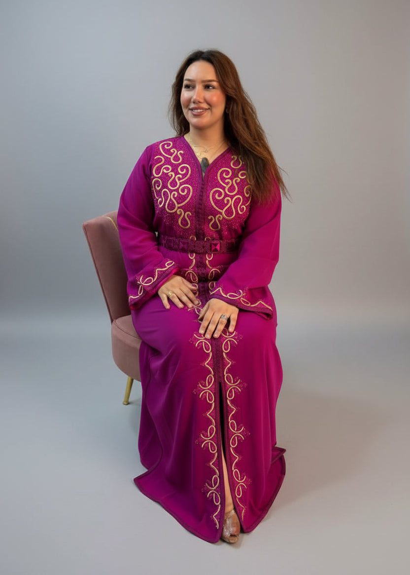 A woman wearing a bright magenta-purple traditional long Moroccan Kaftan with gold embroidery