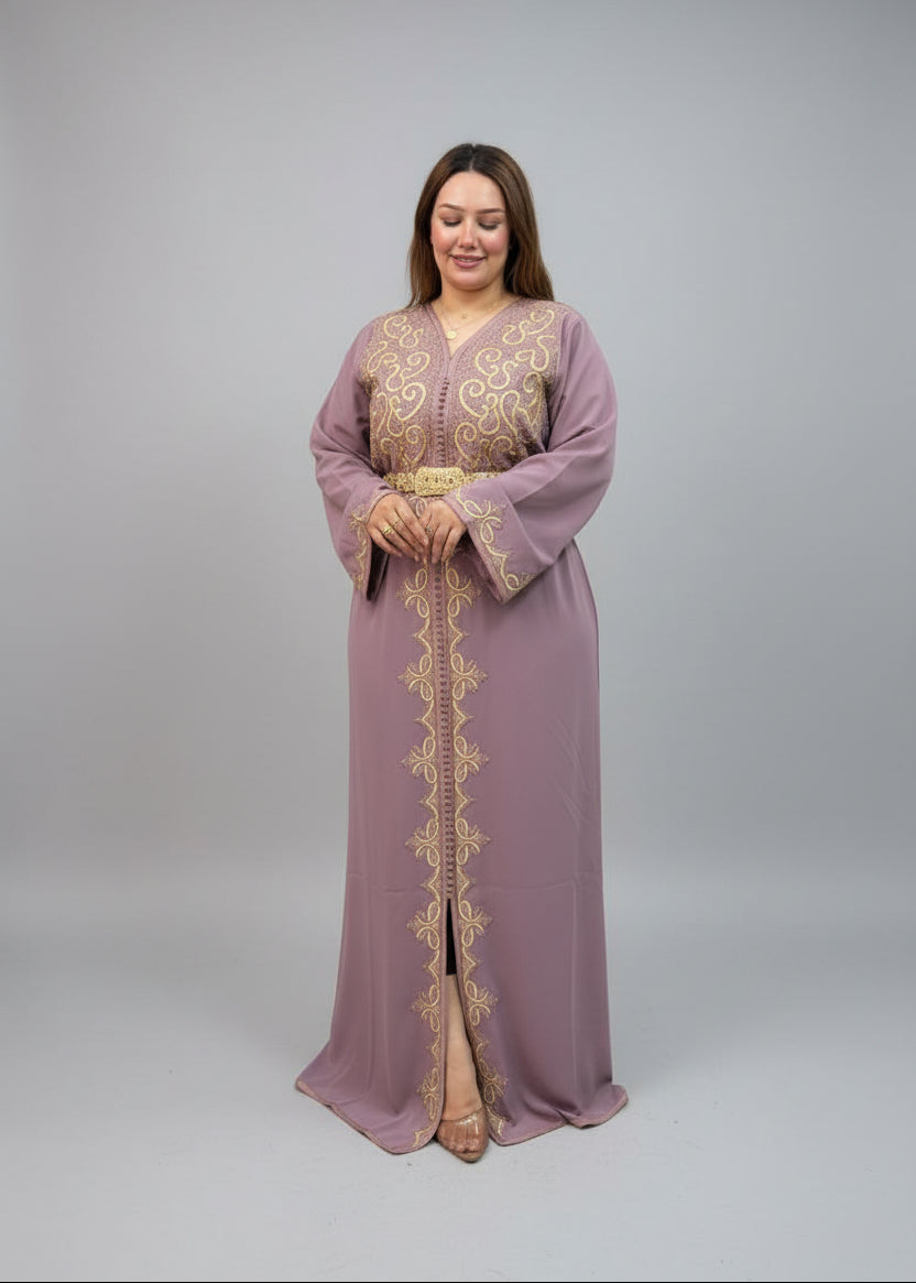 A woman modeling a dusty purple maxi kaftan with gold embroidery