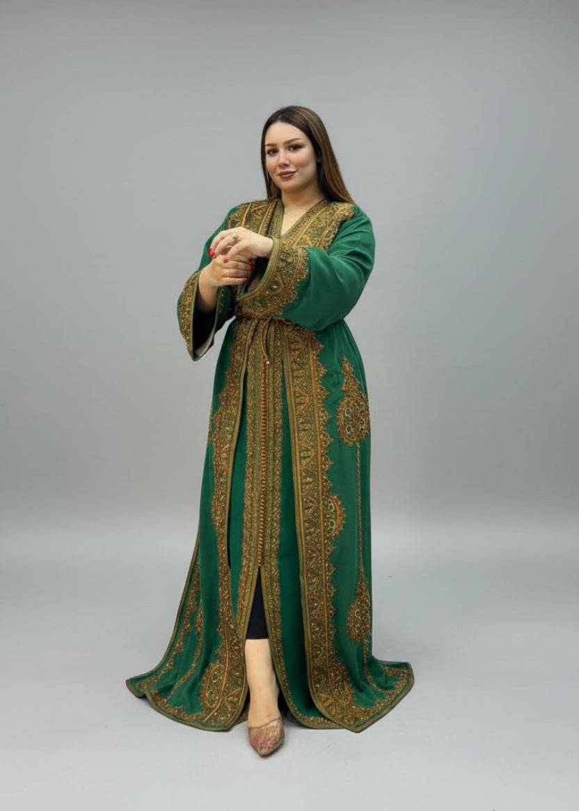 A woman modeling a green and gold embroidered kaftan .