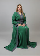 Woman in a green dress with silver trim standing in a store.
"caftan dress"
"women's caftan"
"kaftan"