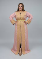 Woman wearing a traditional outfit in a clothing store with shelves of fabric in the background."kaftan dress""
"kaftan dresses"
"women kaftan"
"kaftan women"
"black kaftan"
"kaftan for women"
"men's kaftan"
"maxi kaftan"
"kaftan set"
"long kaftan"
"white kaftan"
"kaftan maxi dress"
"cotton kaftan"
"silk kaftan"
"blue kaftan"
"kaftan men"
"men kaftan"
"what is kaftan"
"caftan"
"moroccan kaftan"
"kaftan moroccan"
"kaftan top"
"embroidered kaftan"
"black kaftan dress"
"long kaftan dress"
"linen kaftan"