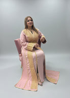 Woman in a pink and gold traditional outfit sitting in a store with fabric displayed on shelves."kaftan dress""
"kaftan dresses"
"women kaftan"
"kaftan women"
"black kaftan"
"kaftan for women"
"men's kaftan"
"maxi kaftan"
"kaftan set"
"long kaftan"
"white kaftan"
"kaftan maxi dress"
"cotton kaftan"
"silk kaftan"
"blue kaftan"
"kaftan men"
"men kaftan"
"what is kaftan"
"caftan"
"moroccan kaftan"
"kaftan moroccan"
"kaftan top"
"embroidered kaftan"
"black kaftan dress"
"long kaftan dress"
"linen kaftan"