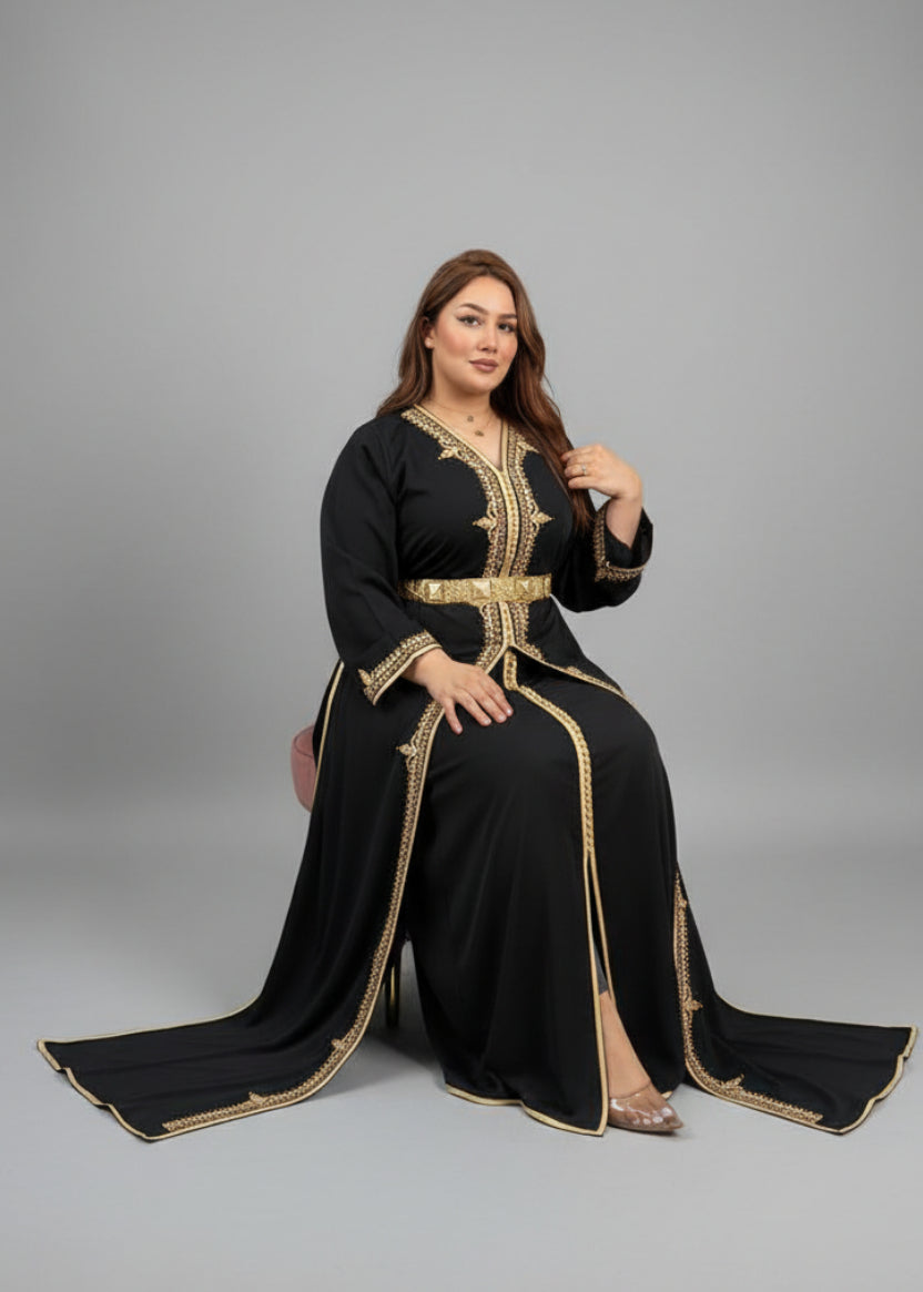 Woman in a black dress with gold embroidery sitting in a store."caftan dress"
"women's caftan"
"kaftan"
"cotton caftan"
"caftan moroccan"
"moroccan caftan"
"men's caftan"
"caftan for women"
"white caftan"
"blue caftan"
"what is caftan"
"caftan dresses"
"caftan men"
"silk caftan"
"vintage caftan"
"maxi dress"
"beach caftan"
"caftan maxi dress"
"caftan for men"
"what is a caftan"
"caftan cover up"
"kaftan dress"
"plus size caftan"
"caftan plus size"
"short caftan"
"linen caftan"
"womens caftan"