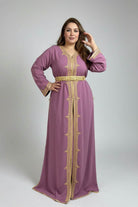 Woman in a purple dress with gold embroidery standing in a clothing store.
"caftan dress"
"women's caftan"
"kaftan"
"cotton caftan"
"caftan moroccan"
"moroccan caftan"
"men's caftan"
"caftan for women"
"white caftan"
"blue caftan"
"what is caftan"
"caftan dresses"
"caftan men"
"silk caftan"
"vintage caftan"
"maxi dress"
"beach caftan"
"caftan maxi dress"
"caftan for men"
"what is a caftan"
"caftan cover up"
"kaftan dress"
"plus size caftan"
"caftan plus size"
"short caftan"
"linen caftan"
"womens caftan"