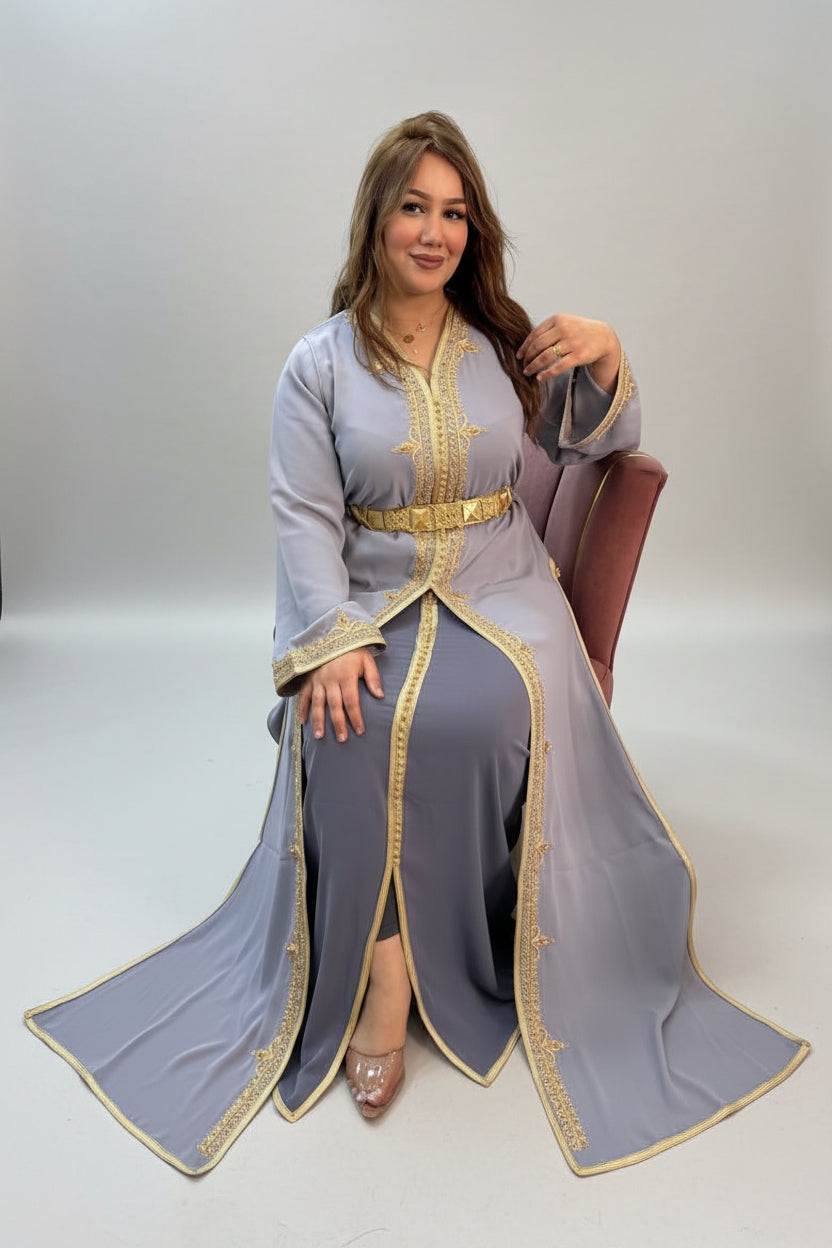 Woman wearing a gray dress with gold accents in a store setting "caftan dress"
"women's caftan"
"kaftan"
"cotton caftan"
"caftan moroccan"
"moroccan caftan"
"men's caftan"
"caftan for women"
"white caftan"
"blue caftan"
"what is caftan"
"caftan dresses"
"caftan men"
"silk caftan"
"vintage caftan"
"maxi dress"
"beach caftan"
"caftan maxi dress"
"caftan for men"
"what is a caftan"
"caftan cover up"
"kaftan dress"
"plus size caftan"
"caftan plus size"
"short caftan"
"linen caftan"
"womens caftan"