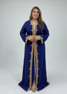 Woman wearing a blue dress with gold embroidery in a clothing store."caftan dress"
"women's caftan"
"kaftan"
"cotton caftan"
"caftan moroccan"
"moroccan caftan"
"men's caftan"
"caftan for women"
"white caftan"
"blue caftan"
"what is caftan"
"caftan dresses"
"caftan men"
"silk caftan"
"vintage caftan"
"maxi dress"
"beach caftan"
"caftan maxi dress"
"caftan for men"
"what is a caftan"
"caftan cover up"
"kaftan dress"
"plus size caftan"
"caftan plus size"
"short caftan"
"linen caftan"
"womens caftan"
"caftan m