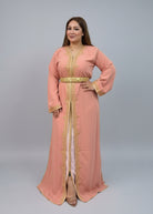 Woman in a peach dress with gold accents standing in a clothing store."caftan dress"
"women's caftan"
"kaftan"
"cotton caftan"
"caftan moroccan"
"moroccan caftan"
"men's caftan"
"caftan for women"
"white caftan"
"blue caftan"
"what is caftan"
"caftan dresses"
"caftan men"
"silk caftan"
"vintage caftan"
"maxi dress"
"beach caftan"
"caftan maxi dress"
"caftan for men"
"what is a caftan"
"caftan cover up"
"kaftan dress"
"plus size caftan"
"caftan plus size"
"short caftan"
"linen caftan"
"womens caftan"
"caftan