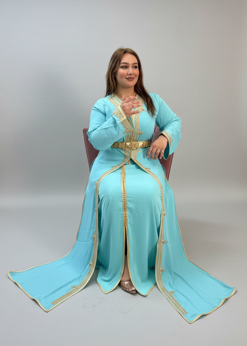 Woman in a turquoise traditional outfit with gold accents in a store setting."caftan dress"
"women's caftan"
"kaftan"
"cotton caftan"
"caftan moroccan"
"moroccan caftan"
"men's caftan"
"caftan for women"
"white caftan"
"blue caftan"
"what is caftan"
"caftan dresses"
"caftan men"
"silk caftan"
"vintage caftan"
"maxi dress"
"beach caftan"
"caftan maxi dress"
"caftan for men"
"what is a caftan"
"caftan cover up"
"kaftan dress"
"plus size caftan"
"caftan plus size"
"short caftan"
"linen caftan"
"womens caftan"
