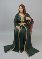 Woman wearing a green dress with gold embroidery in a store setting"caftan dress"
"women's caftan"
"kaftan"
"cotton caftan"
"caftan moroccan"
"moroccan caftan"
"men's caftan"
"caftan for women"
"white caftan"
"blue caftan"
"what is caftan"
"caftan dresses"
"caftan men"
"silk caftan"
"vintage caftan"
"maxi dress"
"beach caftan"
"caftan maxi dress"
"caftan for men"
"what is a caftan"
"caftan cover up"
"kaftan dress"
"plus size caftan"
"caftan plus size"
"short caftan"
"linen caftan"
"womens caftan"