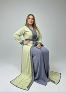 Woman trying on a green and gray traditional outfit in a store.
"caftan dress"
"women's caftan"
"kaftan"
"cotton caftan"
"caftan moroccan"
"moroccan caftan"
"men's caftan"
"caftan for women"
"white caftan"
"blue caftan"
"what is caftan"
"caftan dresses"
"caftan men"
"silk caftan"
"vintage caftan"
"maxi dress"
"beach caftan"
"caftan maxi dress"
"caftan for men"
"what is a caftan"
"caftan cover up"
"kaftan dress"
"plus size caftan"
"caftan plus size"
"short caftan"
"linen caftan"
"womens caftan"
