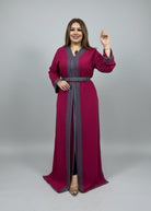 Woman in a red dress with gray trim standing in a store with clothing racks.
"caftan dress"
"women's caftan"
"kaftan"
"cotton caftan"

