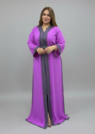 Woman wearing a purple dress with a black border in a fabric store.
"caftan dress"
"women's caftan"
"kaftan"
"cotton caftan"
"caftan moroccan"
