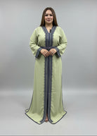 Woman wearing a green dress with intricate detailing in a clothing store.
"caftan dress"
"women's caftan"
"kaftan"
"cotton caftan"
"caftan moroccan"
"moroccan caftan"
"men's caftan"
"caftan for women"
"white caftan"
"blue caftan"
"what is caftan"
"caftan dresses"
"caftan men"
"silk caftan"
"vintage caftan"
"maxi dress"
"beach caftan"
"caftan maxi dress"
"caftan for men"
"what is a caftan"
"caftan cover up"
"kaftan dress"
"plus size caftan"
"caftan plus size"
"short caftan"
"linen caftan"
"womens caftan"
