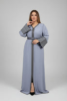 Woman wearing a long, light gray dress with a belt in a fabric store.
"kaftan dress""
"kaftan dresses"
"women kaftan"
"kaftan women"
"black kaftan"
"kaftan for women"
"men's kaftan"
"maxi kaftan"
"kaftan set"
"long kaftan"
"white kaftan"
"kaftan maxi dress"
"cotton kaftan"
"silk kaftan"
"blue kaftan"
"kaftan men"
"men kaftan"
"what is kaftan"
"caftan"
"moroccan kaftan"
"kaftan moroccan"
"kaftan top"
"embroidered kaftan"
"black kaftan dress"
"long kaftan dress"
"linen kaftan"
"abaya"
"kaftan abaya"
