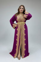 Woman wearing a purple dress with gold embroidery in a clothing store.
"caftan dress"
"women's caftan"
"kaftan"
"cotton caftan"
"caftan moroccan"
"moroccan caftan"
"men's caftan"
"caftan for women"
"white caftan"
"blue caftan"
"what is caftan"
"caftan dresses"
"caftan men"
"silk caftan"
"vintage caftan"
"maxi dress"
"beach caftan"
"caftan maxi dress"
"caftan for men"
"what is a caftan"
"caftan cover up"
"kaftan dress"
"plus size caftan"
"caftan plus size"
"short caftan"
"linen caftan"
"womens caftan"