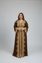 Woman wearing a brown and gold embroidered abaya in a clothing 
store.

"caftan dress"
"women's caftan"
"kaftan"
"cotton caftan"
"caftan moroccan"
"moroccan caftan"
"men's caftan"
"caftan for women"
"white caftan"
"blue caftan"
"what is caftan"
"caftan dresses"
"silk caftan"
"vintage caftan"
"maxi dress"
"beach caftan"
"caftan maxi dress"
"caftan for men"
"what is a caftan"
"caftan cover up"
"kaftan dress"
"plus size caftan"
"caftan plus size"
"short caftan"
"linen caftan"
"womens caftan"
"caftan meaning"