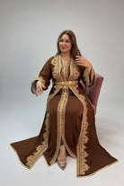 Woman wearing a brown and gold embroidered outfit in a store setting.
"caftan dress"
"women's caftan"
"kaftan"
"cotton caftan"
"caftan moroccan"
"moroccan caftan"
"men's caftan"
"caftan for women"
"white caftan"
"blue caftan"
"what is caftan"
"caftan dresses"
"silk caftan"
"vintage caftan"
"maxi dress"
"beach caftan"
"caftan maxi dress"
"caftan for men"
"what is a caftan"
"caftan cover up"
"kaftan dress"
"plus size caftan"
"caftan plus size"
"short caftan"
"linen caftan"
"womens caftan"
"caftan meaning"