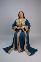 Woman wearing a blue and gold embroidered dress in a store setting.
"caftan dress"
"women's caftan"
"kaftan"
"cotton caftan"
"caftan moroccan"
"moroccan caftan"
"men's caftan"
"caftan for women"
"white caftan"
"blue caftan"
"what is caftan"
"caftan dresses"
"silk caftan"
"vintage caftan"
"maxi dress"
"beach caftan"
"caftan maxi dress"
"caftan for men"
"what is a caftan"
"caftan cover up"
"kaftan dress"
"plus size caftan"
"caftan plus size"
"short caftan"
"linen caftan"
"womens caftan"
"caftan meaning"
"caft
