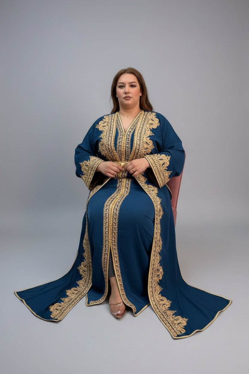 Woman wearing a blue and gold embroidered caftan in a store setting.
