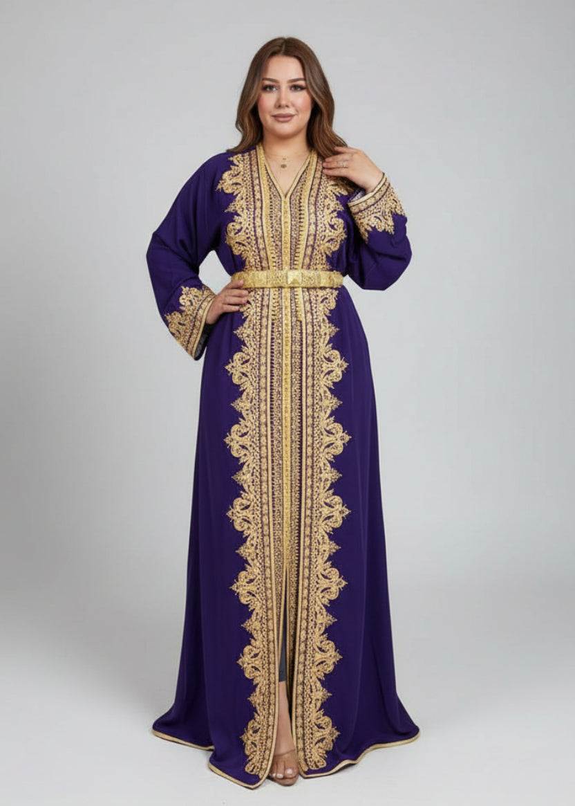 Woman wearing a purple moroccan caftan with gold embroidery in a kaftan store.
