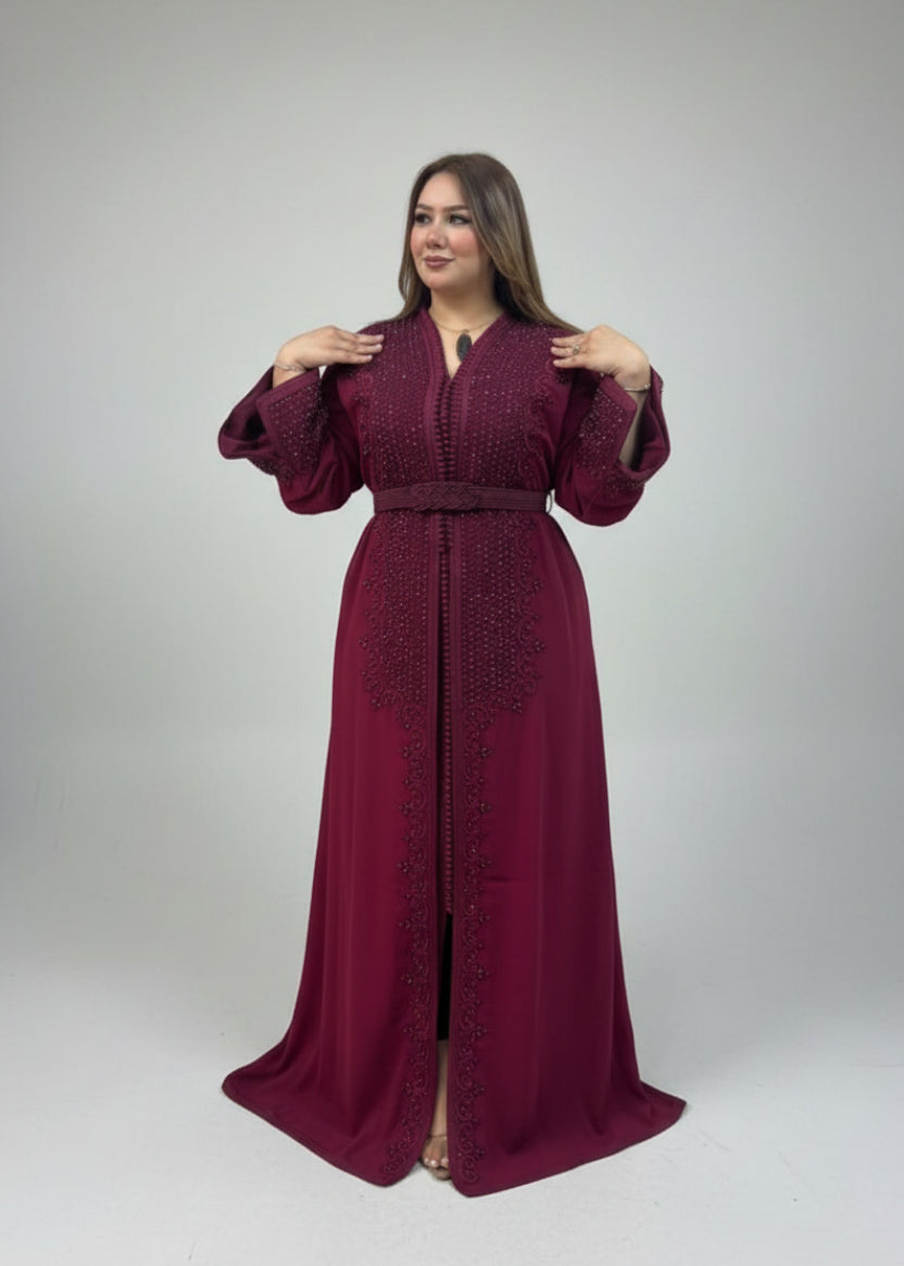 Woman wearing a burgundy dress with intricate detailing in a clothing"kaftan dress""
"kaftan dresses"
"women kaftan"
"kaftan women"
"black kaftan"
"kaftan for women"
"men's kaftan"
"maxi kaftan"
"kaftan set"
"long kaftan"
"white kaftan"
"kaftan maxi dress"
"cotton kaftan"
"silk kaftan"
"blue kaftan"
"kaftan men"
"men kaftan"
"what is kaftan"
"caftan"
"moroccan kaftan"
"kaftan moroccan"
"kaftan top"
"embroidered kaftan"
"black kaftan dress"
"long kaftan dress"
"linen kaftan"
"abaya"
"kaftan abaya"
