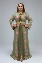 Woman wearing a green embroidered dress in a clothing store.
"caftan dress"
"women's caftan"
"kaftan"
"cotton caftan"
"caftan moroccan"
"moroccan caftan"
"men's caftan"
"caftan for women"
"white caftan"
"blue caftan"
"what is caftan"
"caftan dresses"
"caftan men"
"silk caftan"
"vintage caftan"
"maxi dress"
"beach caftan"
"caftan maxi dress"
"caftan for men"
"what is a caftan"
"caftan cover up"
"kaftan dress"
"plus size caftan"
"caftan plus size"
"short caftan"
"linen caftan"
"womens caftan"
"caftan meaning"